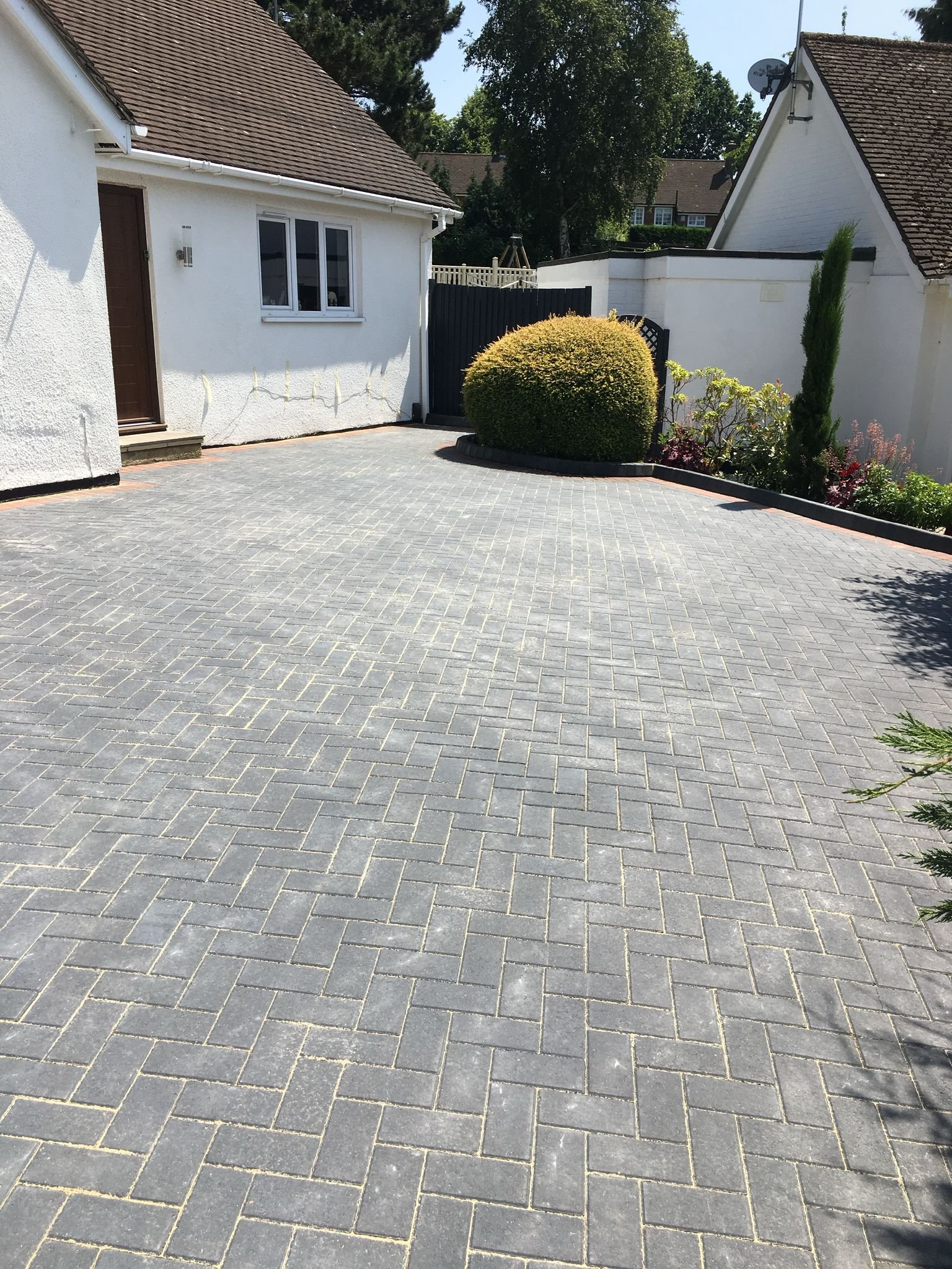 Block paving driveway with decorative brick border installed by MUHAJ in St Albans residential property