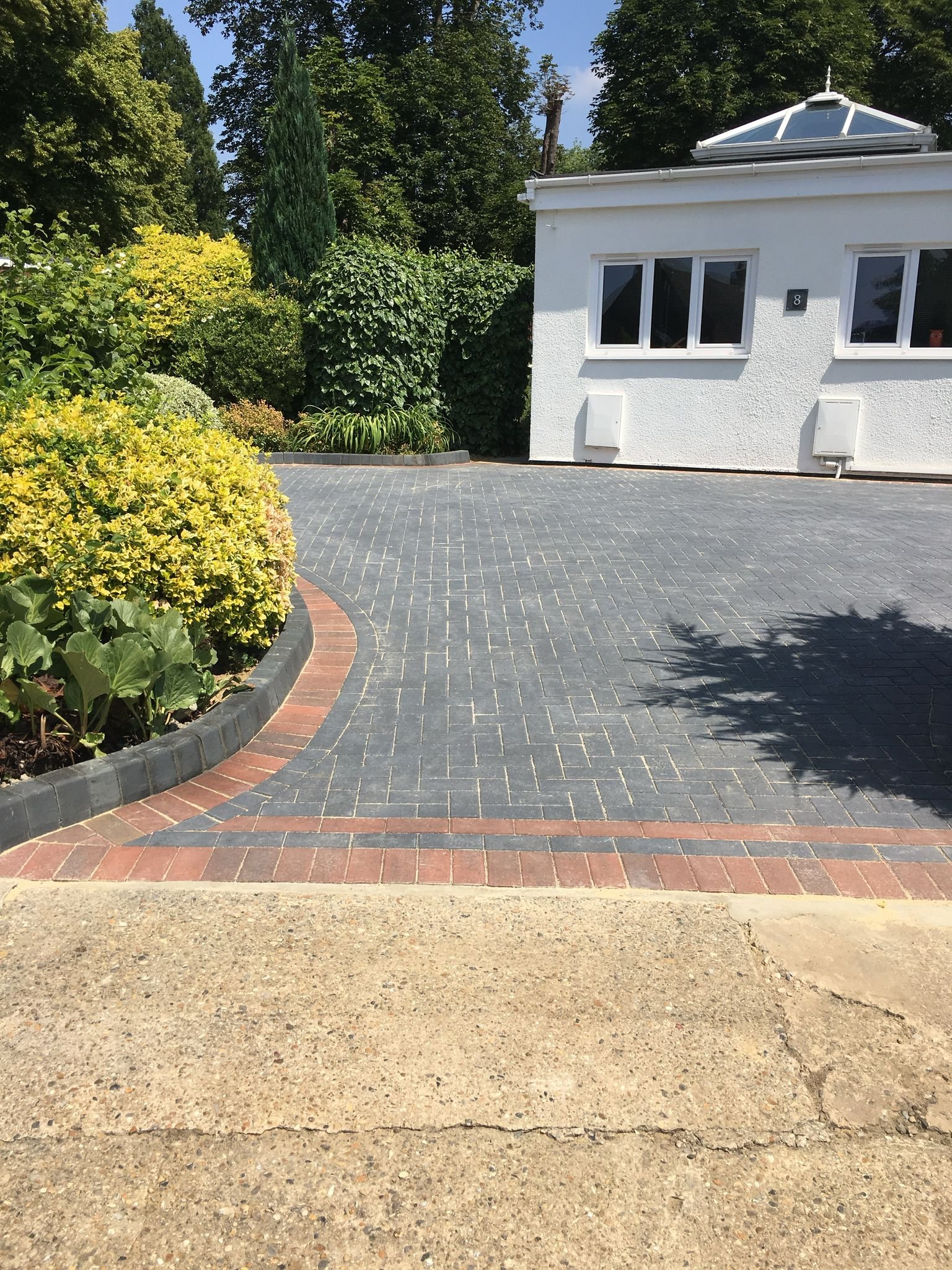 Block paving driveway with decorative brick border installed by MUHAJ in St Albans residential property