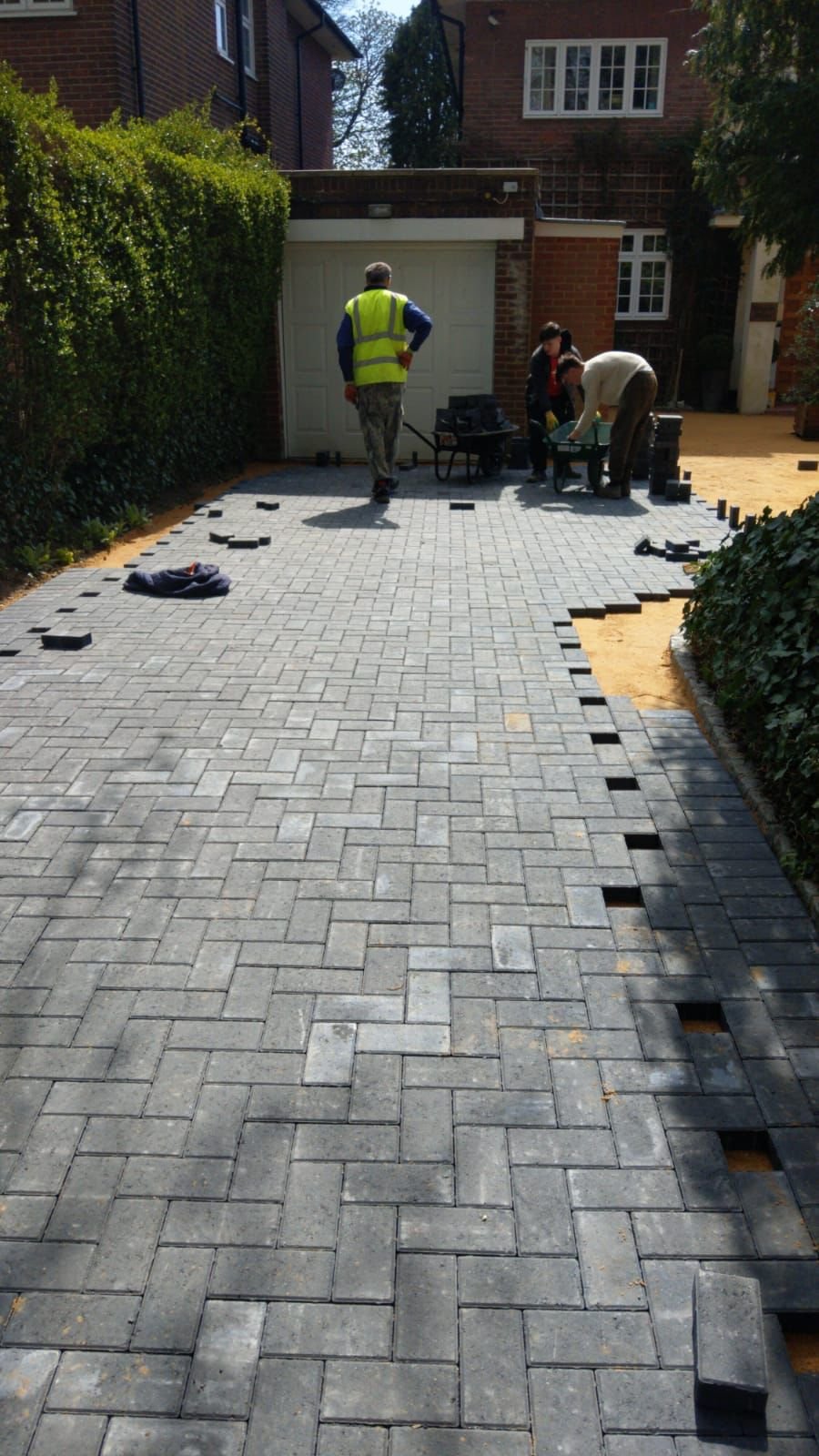 Block paving driveway installation in progress by MUHAJ team in Borehamwood residential area