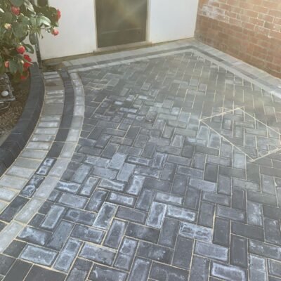 Curved edge block paving driveway with light and dark contrast finish by MUHAJ in Hertfordshire