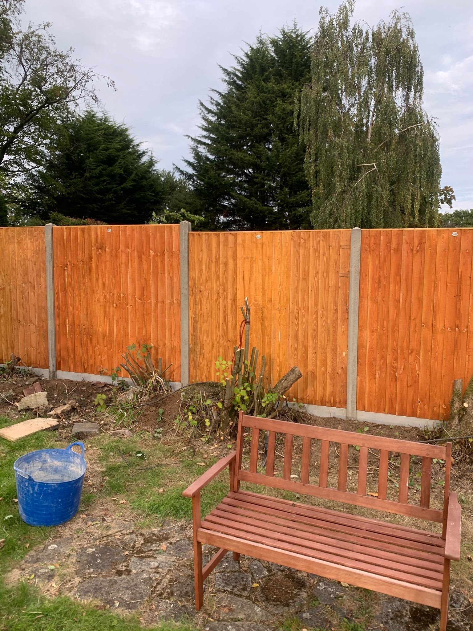 Site preparation with mini digger next to new fencing installation by MUHAJ in Edgrware