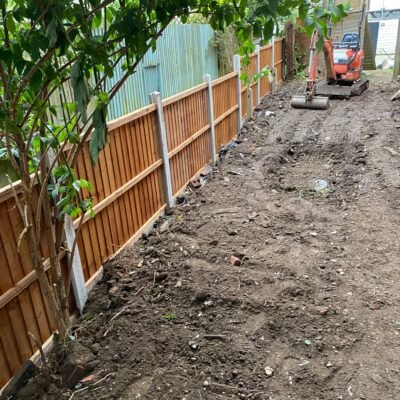 Site preparation with mini digger next to new fencing installation by MUHAJ in North London garden